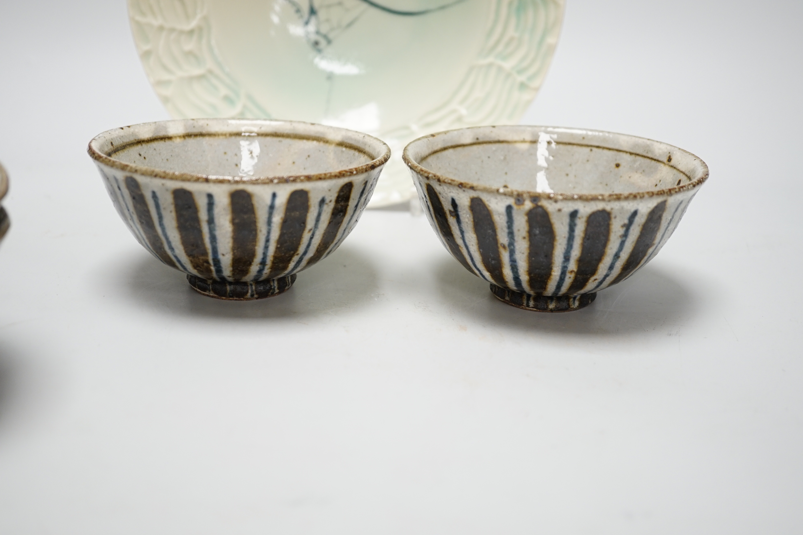 Two pairs of Japanese studio pottery bowls, a European studio bowl and similar ceramic mask raised on hexagonal base, the largest 33cm high